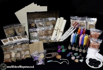 Comprehensive witchcraft kit featuring herbs, candles, crystals, scrolls, oils, and other mystical tools, ideal for spell casting, rituals, and spiritual practices.